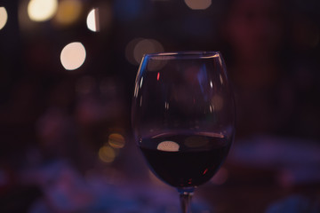 bokeh night glass of red wine valentines day