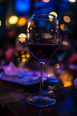 Fototapeta na wymiar bokeh night glass of red wine valentines day