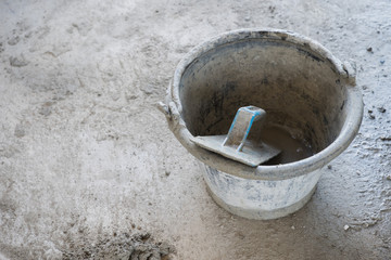 Fototapeta premium plastic trowel in bucket, equipment for used in Construction building.