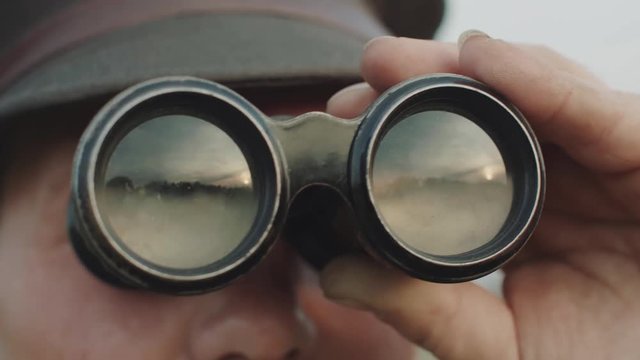 Person Explores Terrain Through Binoculars.
