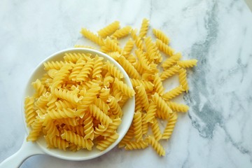 Close up of uncooked pasta fusilli in the bowl