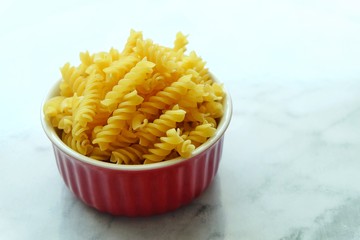 Close up of uncooked pasta fusilli in the bowl
