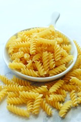 Close up of uncooked pasta fusilli in the bowl