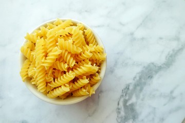 Close up of uncooked pasta fusilli in the bowl