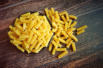 Close up of uncooked pasta fusilli in the bowl