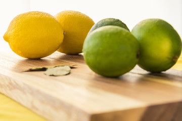 Lemons and Limes on an a Wooden Cutting Board