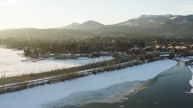 Sandpoint Idaho Aerial Flying Away From City Snowy Winter Day Sunset
