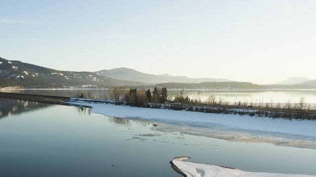 Sandpoint Idaho Vehicle Traffic Bridge Crossing Snowy Lake Pend Oreille Aerial Drone View