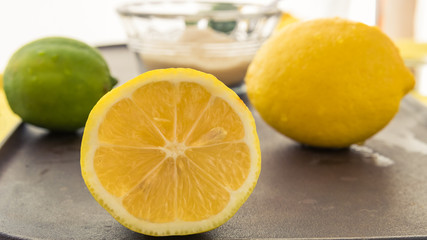 Fototapeta na wymiar A Juicy Lemon Half and Whole Fruit and Sugar