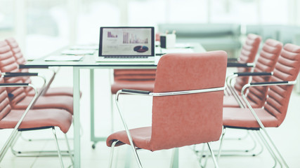  open laptop computer with financial charts on the table with the Manager in a modern office.