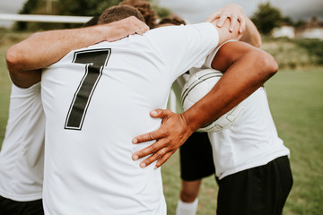 Football players huddling before a match