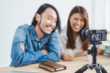 Two of young Asian blogger or vlogger using video online live streaming and broadcasting