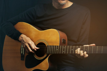 Close up man playing guitar