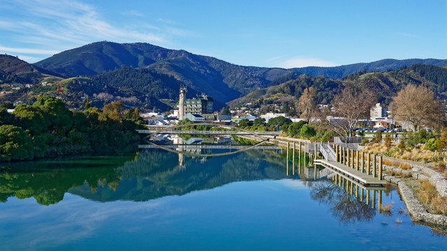 Panorama of Nelson City, reflected in the Maitai River, New Zealand.