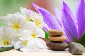 Zen spa concept background - Zen massage stones with frangipani plumeria flower