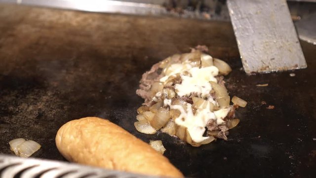 Cooking Philly beef cheese steak on hot plate