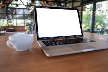 mock up Using laptop with blank screen computer modern Workspace in coffee shop