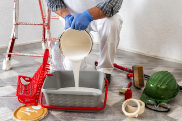 Professional house painter at work prepares the wall paint © francescomou