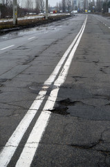 Poor condition of the road surface. Winter season. Wet and foggy weather. Residential area of Kiev. 
