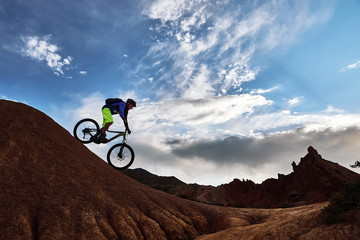 Cyclist riding a mountain bike downhill style in a canyon 