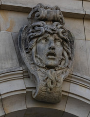 Stone face on the side of a bridge