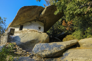 ancient Theoktistis monastery with impressive rock shelter on a stone chapel on Ikaria island