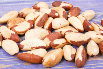 Heap of brazil nuts on old purple boards