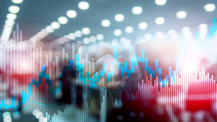 Stock trading candlestick chart and diagrams on blurred office center background.