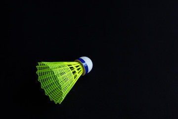 Plastic shuttlecock on black background.