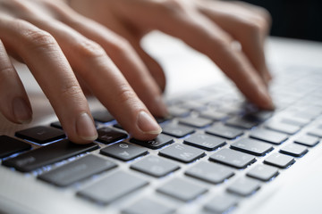 Business woman typing on keyboard. Shallow dof.