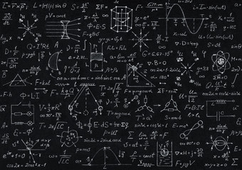 Blackboard inscribed with scientific formulas and calculations in physics, mathematics and...