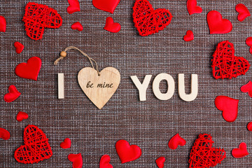 Declaration of love with decorative hearts on sackcloth background. Valentine's day concept.