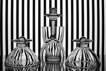 Compositions of glassware on a striped background.