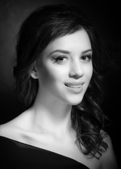 Portrait of a beautiful brunette on a dark background.