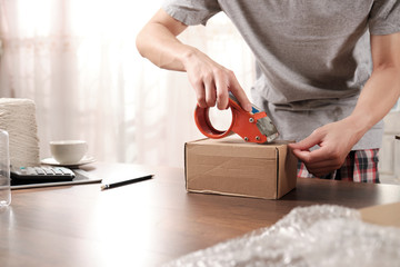 Close-up of Startup business owner packing cardboard box. about shopping online.