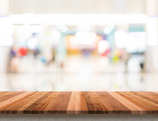 Empty wood table top with blur department store boekh background,Mock up template for display or montage of product or content use as banner in social media ads.