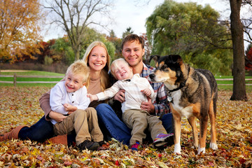 Portrait of a Happy Family of Mother Father and Two Kids and Their Dog on an Autumn Day