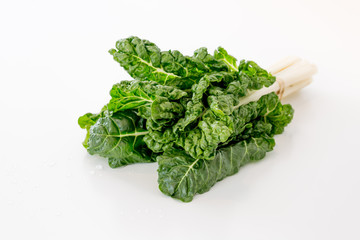 isolated picture of a bunch of chard/ silver beet on a white surface