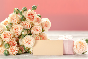 Pink roses flowers and gift or present box pink background. Mothers Day, Birthday, Valentines Day, Womens Day, celebration concept.