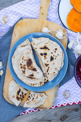 Hot chapati naan bread stuffed with sweet pumpkin. Indian traditional paratha. Food made of whole wheat and fried on dry pan or skillet. Vegan vegetarian healthy food. Flatbread roti.