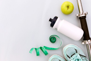 Accessories for sports on blue background flat lay top view. Fitness, healthy and active lifestyles. Place for text.