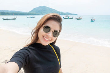  woman tourist is selfie  in Phuket sea in Thailand