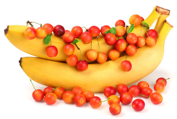 Bananas and plums isolated on white