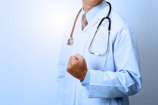 Male doctor in fighting position with fists up