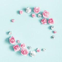 Flowers composition. Wreath made of rose flowers on pastel blue background. Valentines day, mothers...