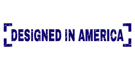 DESIGNED IN AMERICA text seal watermark with corroded texture. Text title is placed between corners. Blue vector rubber print of DESIGNED IN AMERICA with corroded texture.
