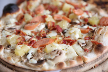 Pizza sausage bacon and pineapple on wooden , pizza hawaiian