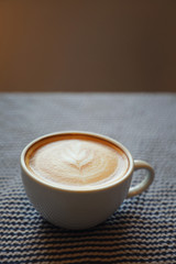 cappuccino or Latte art coffee made from milk on the wood table in coffee shop