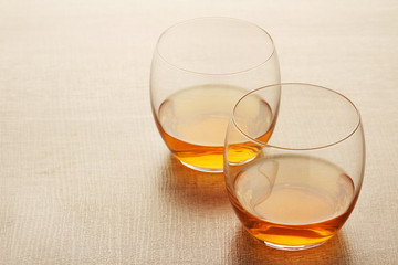 Two glasses with whiskey without ice cubes	