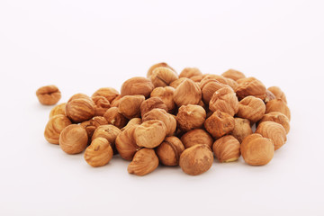 A pile of hazelnuts at white background	